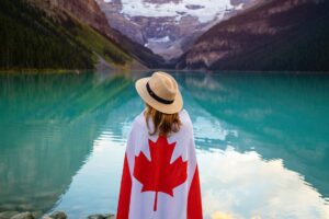 photo of woman standing near the lake